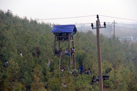 Nhiều người dân đã treo lên cả chòi canh để dõi theo đoàn xe tang Đại tướng.