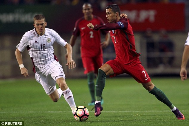 
C.Ronaldo (phải) đi bóng trước sự truy cản của cầu thủ Latvia
