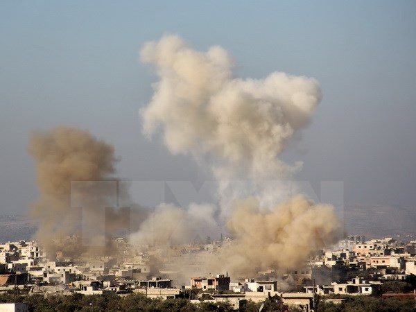 Quân nổi dậy lại oanh kích gần thành phố Aleppo của Syria - 1 Khói bốc lên sau vụ nã pháo của lực lượng nổi dậy nhằm vào các mục tiêu của quân Chính phủ ở thị trấn Fuaa, phía tây bắc tỉnh Idlib ngày 6/12 vừa qua. (Ảnh: AFP/TTXVN)