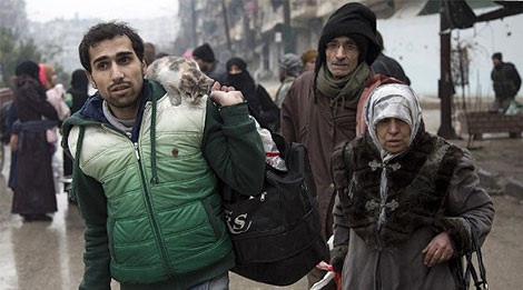 Aleppo sụp đổ, lụi tàn "dự án" can thiệp vào Syria của phương Tây - 2 Người dân Syria rời khỏi một khu vực bị phiến quân chiếm giữ ở Aleppo ngày 13-12.
