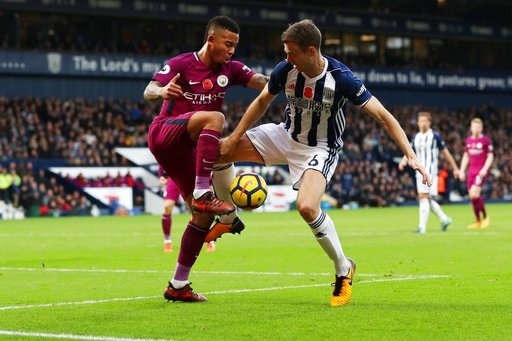 
Jesus (trái) tranh bóng với Evans (phải)
