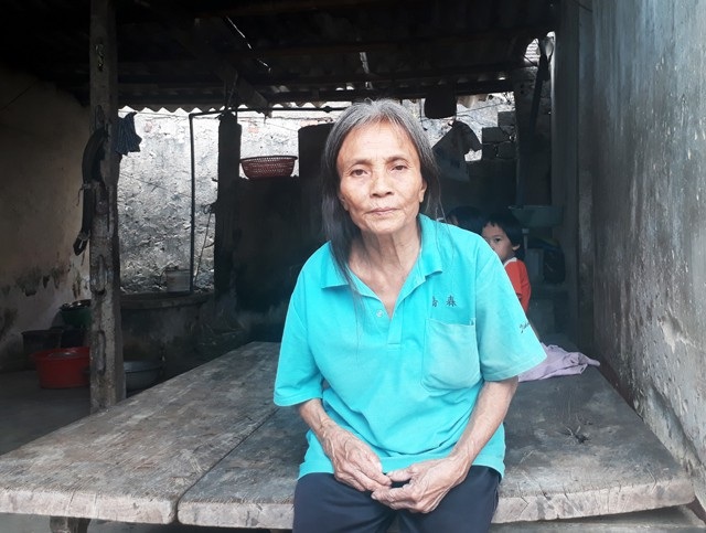 Bà Vũ Thị Quy - mẹ chồng chị Nhất bị tai biến, liệt nửa người, cánh tay phải co quắp, chân đi lại khó khăn, gần như mất khả năng lao động