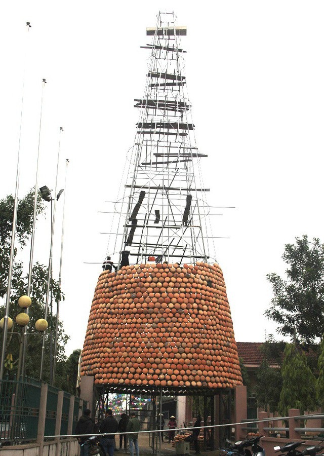 Với ý tưởng quảng bá được sản phẩm của làng nghề cũng như tạo điểm nhấn đặc biệt để chào mừng mùa Lễ Giáng sinh 2017, bà con giáo dân Lưu Mỹ, ở xã Trù Sơn, huyện Đô Lương (Nghệ An) đã dựng một cây thông Noel từ hơn 5000 chiếc nồi đất. (Ảnh: Nguyễn Duy)