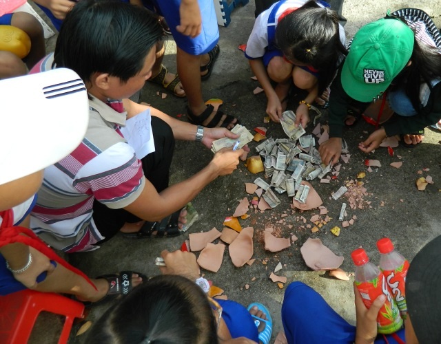 Học sinh khui heo đất tiết kiệm khuyến học - 4 Các em đã tiết kiệm từng đồng tiền lẻ để nuôi cho heo đất no bụng, từ đó cùng nhau góp phần vào phong trào khuyến học, khuyến tài.
