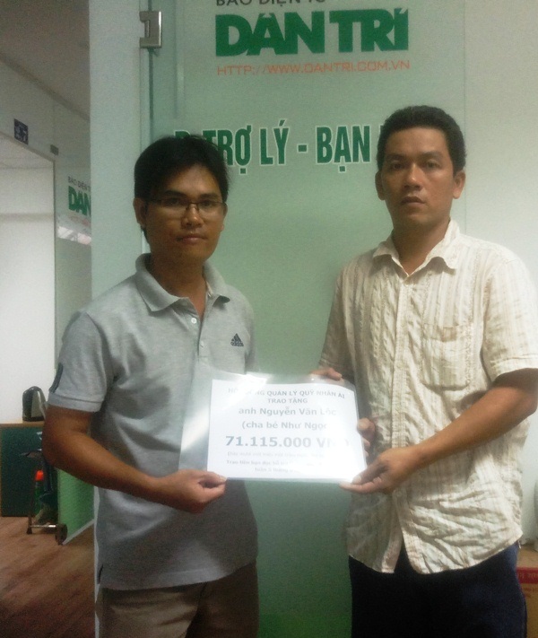 Anh Nguyễn Văn Lộc (phải) nhận quà bạn đọc ủng hộ cho bé Như Ngọc