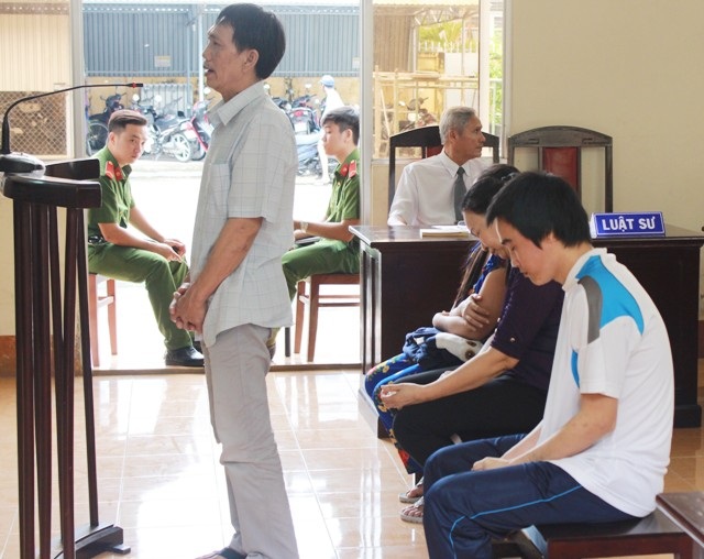Hầu tòa vì bán 7 phụ nữ Việt sang làm vợ đàn ông Trung Quốc - 1 Các bị cáo trước vành móng ngựa. Trong ảnh là bị cáo Lê Tấn Phong (đứng), một trong những người có vai trò giúp sức cho chủ mưu vụ án là Lý Búp Pha.