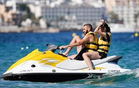 Handsome Benzema rides a jet ski next to his wife
