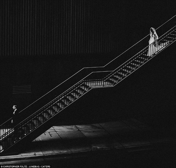 Chỉ vài phút nữa, cô dâu nắm tay chú rể của mình bên dưới chân cầu thang.