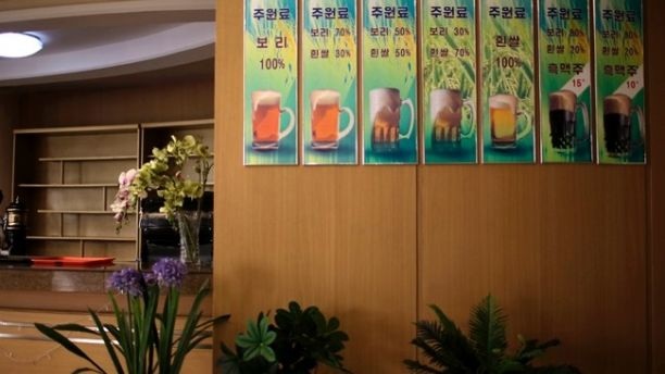 Bên trong nhà máy bia nổi tiếng tại Triều Tiên - 3 Mặc dù không phổ biến như rượu soju nhưng bia cũng là đồ uống được sử dụng rộng khắp tại Triều Tiên và được bán với giá rẻ. Nửa lít bia Taedonggang chỉ có giá khoảng 2 USD. Trong ảnh: Một nhà hàng trưng ảnh giới thiệu 7 loại bia đặc biệt của nhà máy bia Taedonggang.