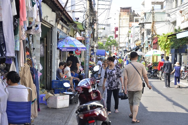 Vỉa hè được tổ chức như thế nào để bảo vệ người đi bộ? - 3 Vỉa hè đường Bà Lê Chân (quận 1) tràn ngập các quầy hàng, người đi bộ bị đẩy xuống đường.Ảnh chụp ngày 11/4 (ảnh Đình Thảo)