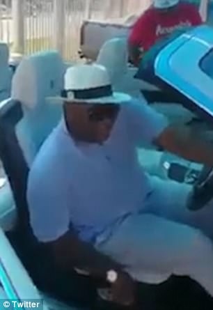“Quý tử” nhà Đệ nhất phu nhân Zimbabwe tậu hai siêu xe liên tiếp - 4 Hình ảnh từ đoạn video được chia sẻ trên mạng xã hội cho thấy Russell Goreraza đã ngồi vào ghế lái để thử nghiệm hai siêu xe màu trắng mới. (Ảnh: Dailymail)