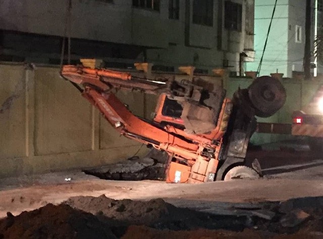 Người cùng xe máy tại một khu dân cư bất ngờ bị một hố tử thần rộng hàng chục mét vuông “nuốt” gọn. Thậm chí máy xúc đến khắc phục hậu quả cũng bị hố sâu cuốn xuống luôn.