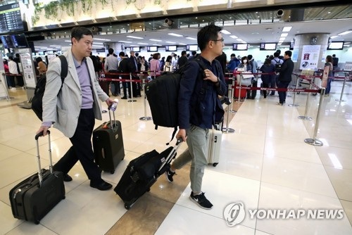 Triều Tiên phá hủy cơ sở hạt nhân: Phóng viên nước ngoài "méo mặt" vì phí visa? - 1 Các phóng viên Hàn Quốc làm thủ tục tại sân bay Gimpo hôm 21/5 trước khi tới Trung Quốc để di chuyển sang Triều Tiên đưa tin về vụ đánh sập khu thử hạt nhân (Ảnh: Yonhap)