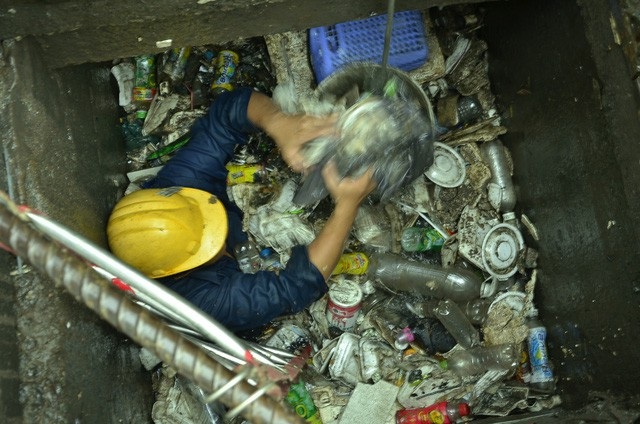 171 tỷ đồng thuê máy bơm “siêu khủng” chống ngập trong 7 năm? - 2 Công nhân vớt rác dưới cống đường Nguyễn Hữu Cảnh (ảnh: Đình Thảo)