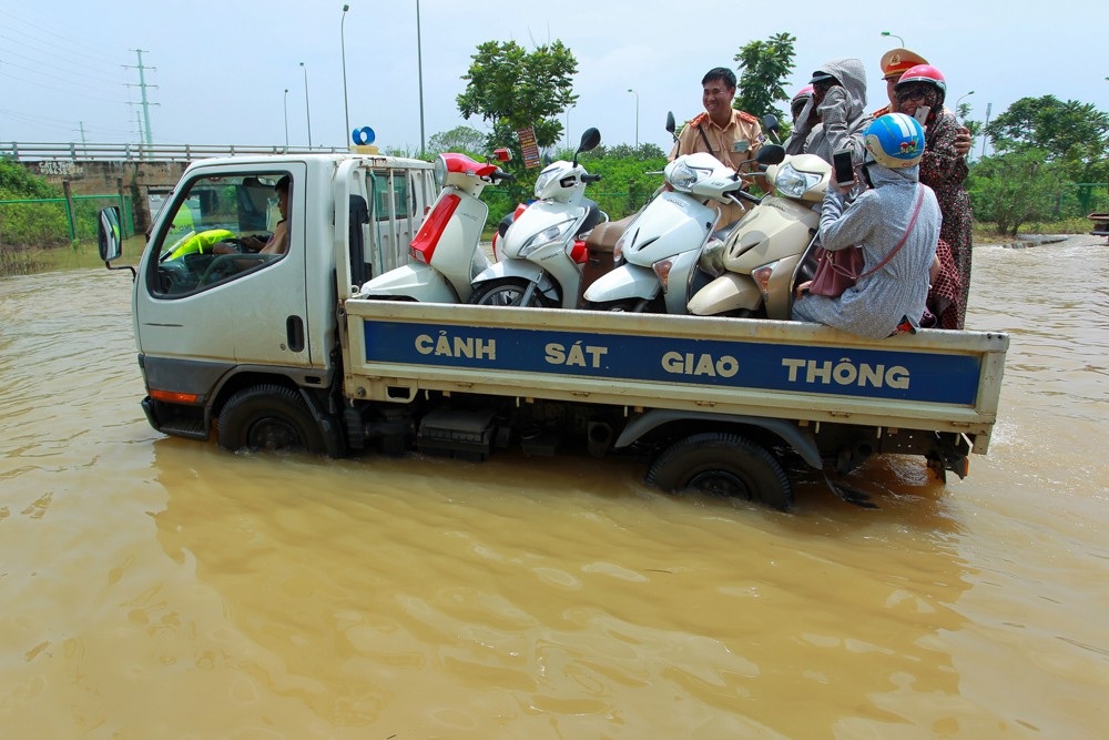 CSGT Hà Nội dùng xe tải chở người dân qua điểm ngập - 9
Chị Nguyễn Thị Hạ (Quốc Oai, Hà Nội) cho biết, đoạn đường này ngập đã bị chia cách nhiều ngày, từ khi có lực lượng CSGT ra giúp người dân, chi mới có thể đi qua.