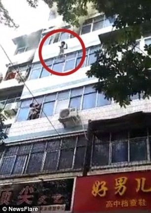 Cháy nhà, mẹ tuyệt vọng ném hai con từ tầng 4 trước khi thiệt mạng - 1 Một đứa trẻ được mẹ ném từ cửa sổ tầng 4 khi xảy ra hỏa hoạn (Ảnh: Newsflare)