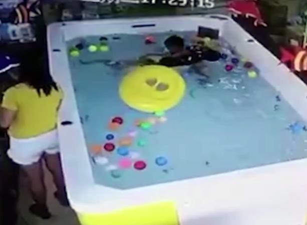 Mải nhắn tin, mẹ để con gái đuối nước trong bể bơi mừng sinh nhật 1 tuổi - 2 Bé gái ngã ra khỏi phao và chỉ có cậu bé cùng bể phát hiện