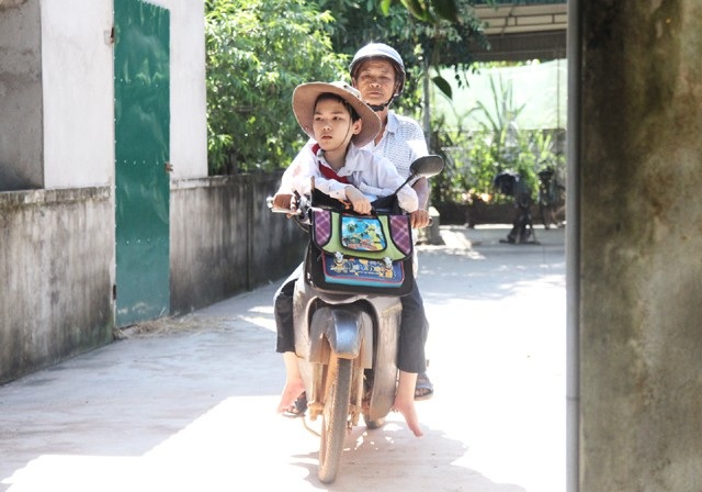 Người cha 10 năm "vác" 2 con đi học - 1 10 năm nay, ông Sơn hàng ngày chở 2 con đi học. Năm nay, cô con gái lên cấp 3 nhưng trường xa phải nghỉ học, ông Sơn ngày 2 buổi đưa con trai Nguyễn Văn Sáng tới trường.