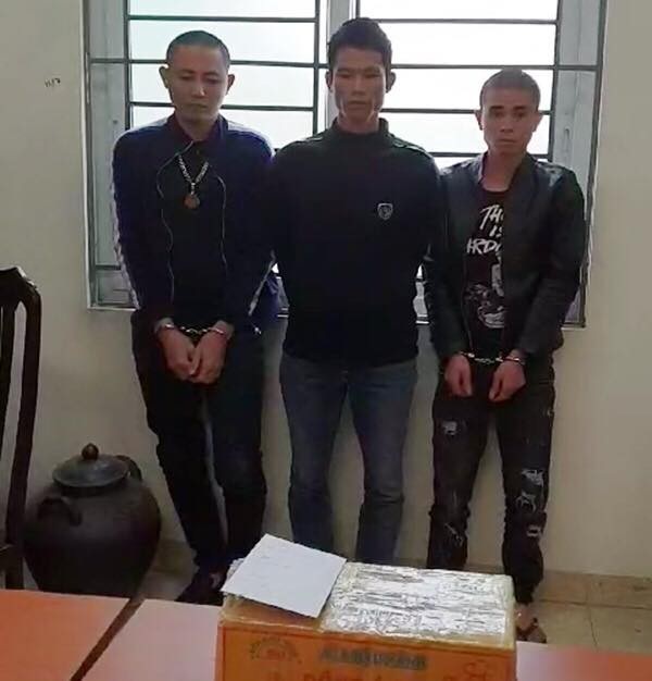 Nam thanh niên đóng thùng 7 bánh heroin rồi gửi xe khách về Hà Nội - 1 Dương Văn Tuấn (ngoài cùng bên trái) cùng hai đối tượng liên quan và tang vật tại cơ quan Công an (Ảnh: Công an cung cấp)