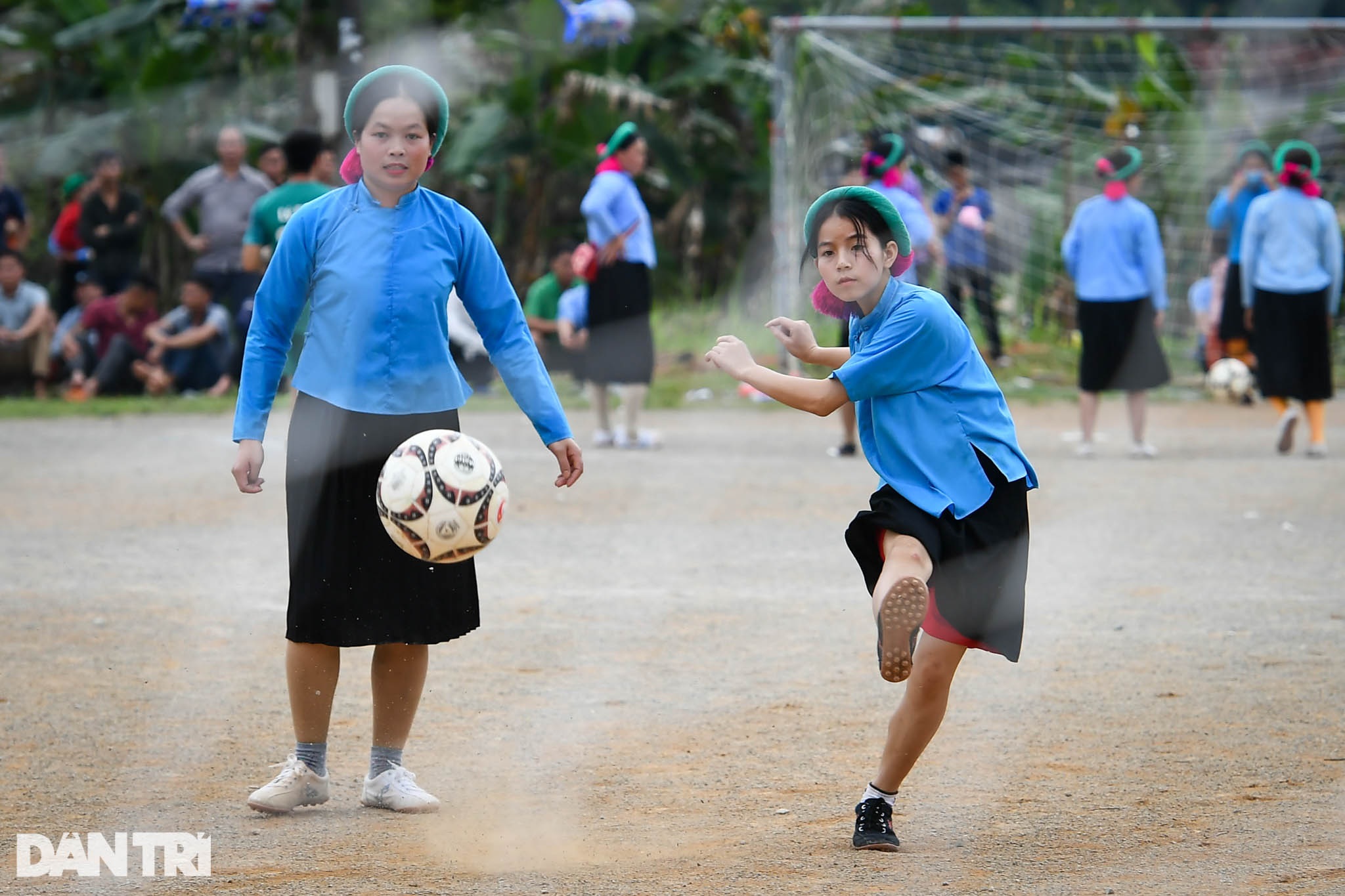 Watching ethnic sisters wearing skirts and shoes to play football on the high mountain - 2