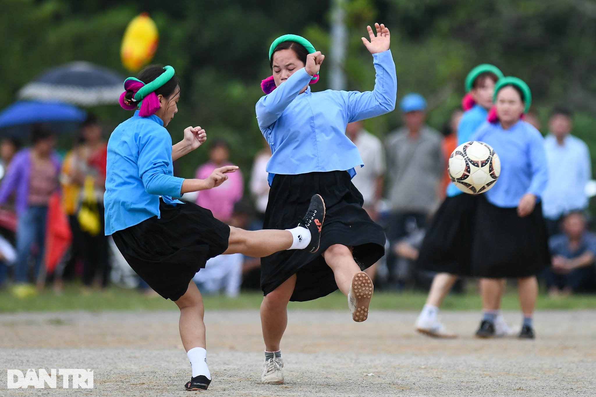 Watching ethnic women wearing skirts and shoes to play football on the high mountain - 23