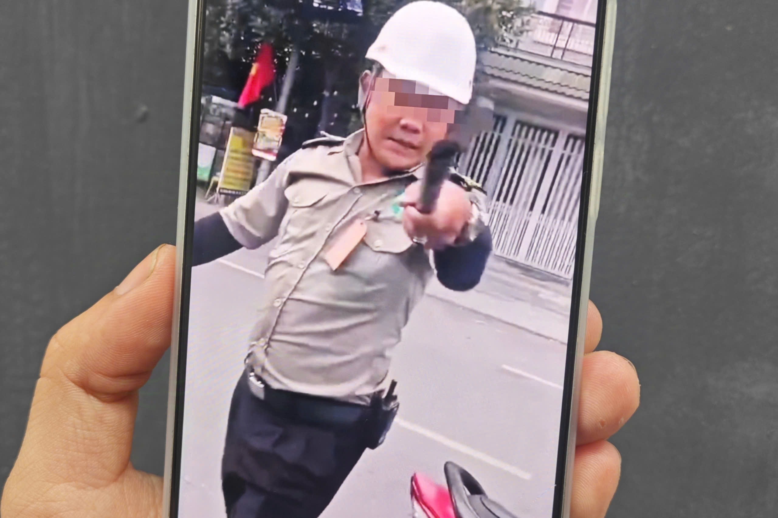 Hai người mặc đồ bảo vệ chặn ô tô, đe dọa tài xế ở TPHCM