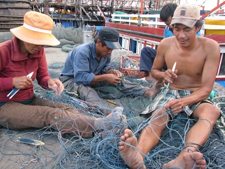 Ngư dân miền Trung đang vá lưới chuẩn bị cho những chuyến ra khơi