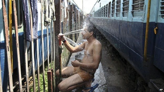 500 người chết vì nắng nóng ở Ấn Độ - 1 Một hành khách đi tàu tắm để hạ nhiệt tại ga ở Jammu (Ảnh: