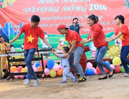 Nghỉ Tết sớm, một số tuyển thủ U19 Việt Nam tranh thủ làm từ thiện - 1 Tuyển thủ U19 Quang Huy (phải) tham gia chương trình giúp đỡ cộng đồng đón Tết