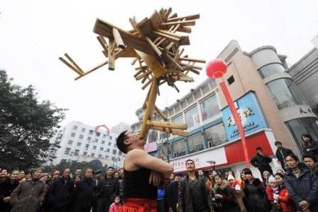 “Nâng bổng” 23 chiếc ghế gỗ bằng… răng - 1