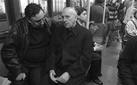 Jorge Mario Bergoglio nói chuyện với một hành khách khi đi trên xe điện ngầm ở Buenos Aires.