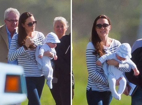 Hoàng tử George tỏ ra ngoan ngoãn khi được mẹ bế.