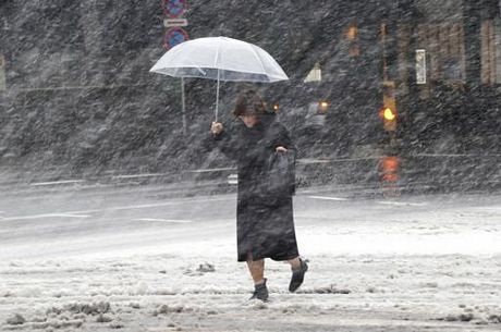 Một phụ nữ di dưới trời mưa tuyết ở thủ đô Tokyo ngày 8/2.