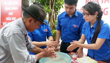 Các tình nguyện viên hướng dẫn người dân sử dụng xà bông trước khi vệ sinh cá nhân.