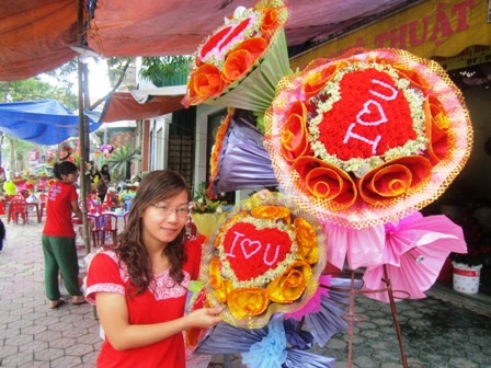 Chị Cao Thị Mai Lê, đang giới thiệu những bó hoa do mình tự tay làm với giá từ 200 - 250.000/1 bó.