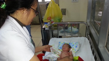 Bác sỹ Hương - Trưởng khoa sơ sinh - BV Sản Nhi Nghệ An đang chăm sóc cháu Hưng.