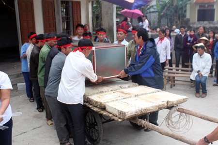 Hàng trăm ngư dân mai táng cá voi dạt vào bờ biển - 1 Các ngư dân ở xã Diễn Thịnh đặt cá Ông cẩn thận vào hòm bằng kính.