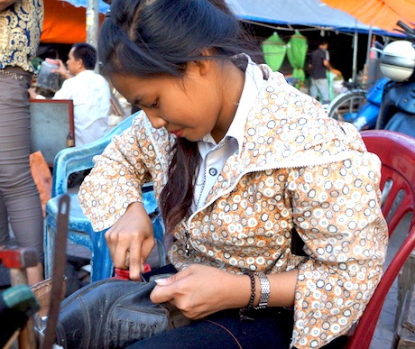 Học bổng Việt Kiều Pháp đến với em Ngô Thị Lợi năm học cuối - 1 Ngoài thời gian lên lớp, em Ngô Thị Lợi ra chợ Vinh khâu giày dép cho khách.