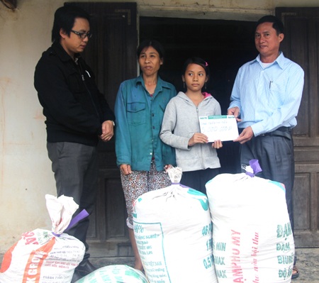 Các ban ngành hỗ trợ PV mang gạo vào nhà giúp bà Hương, cháu Tân.