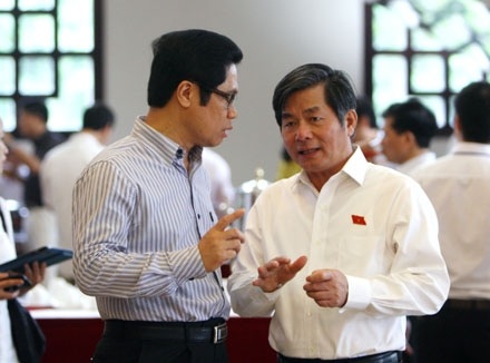 Bộ trưởng Bùi Quang Vinh (phải) trao đổi bên hành lang Quốc hội