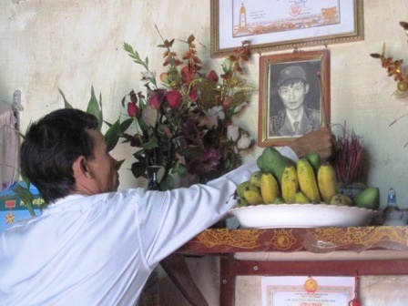 Anh Bài thắp hương cho anh trai trong ngày giỗ.