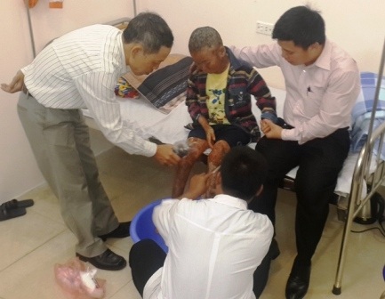 Các bác sĩ, lương y phòng khám Thiên Phú Đường bôi thuốc chữa bệnh vảy nến cho cháu Kỳ.