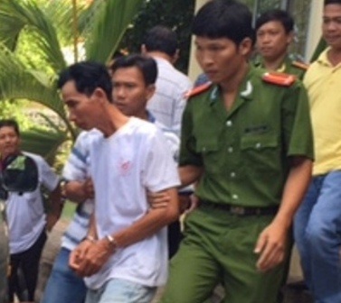 Đối tượng Gia bị cơ quan công an bắt giữ để để điều tra hành vi phóng hỏa, giết người