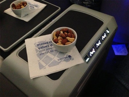 Sau khăn ấm là một cốc hạt rang còn nóng.