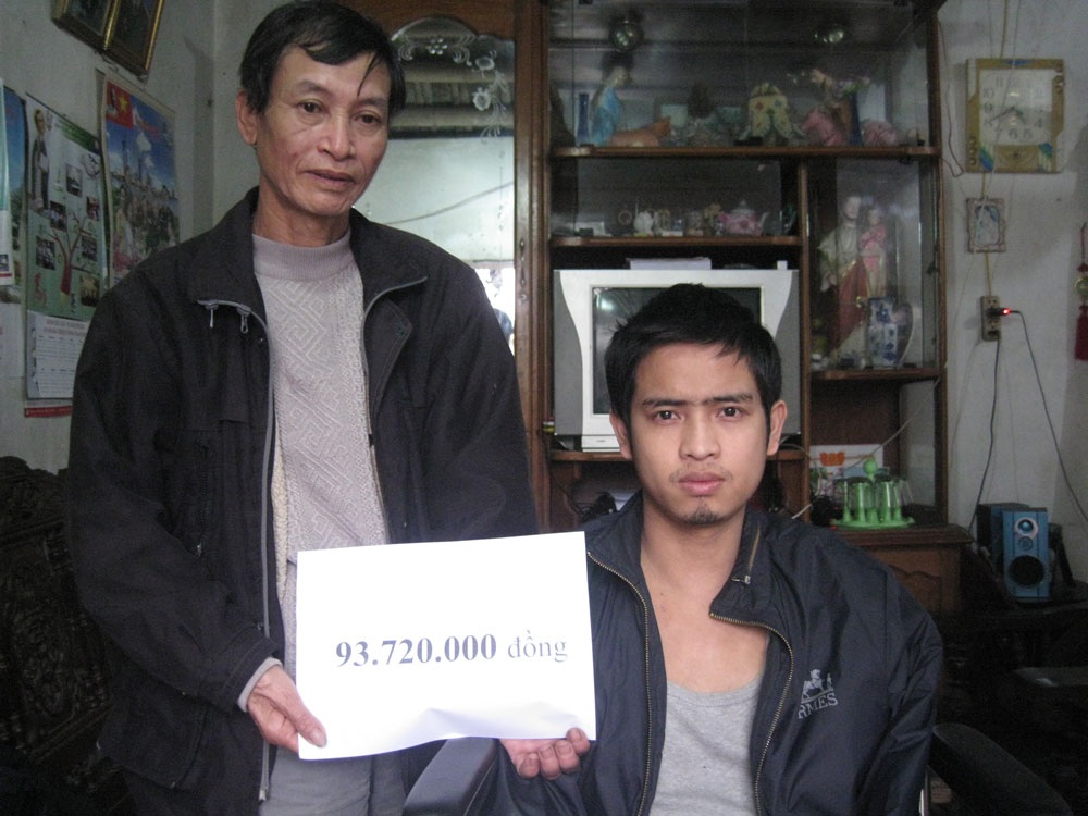 Hai bố con anh Phạm Đức Mạnh nhận số tiền 93.720.000 đồng do bạn đọc Dân trí ủng hộ qua Quỹ Nhân ái