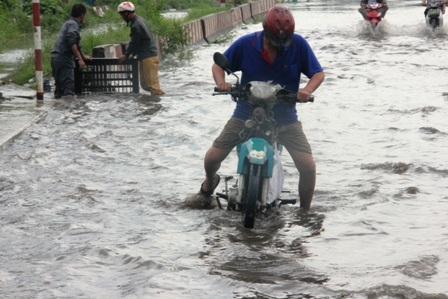 Hàng loạt phương tiện bì bõm lội qua khu vực ngập nước, nhiều xe bị chết máy phải dắt bộ lên cầu.