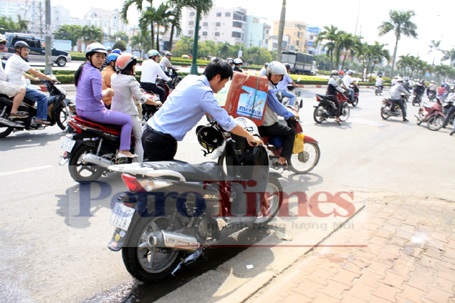 Xe SH đang chạy bỗng dưng bốc cháy - 2 Người dân dùng bình cứu hỏa của tòa nhà gần đó để dập tắt ngọn lửa trên xe