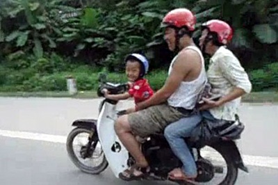 Hình ảnh cậu bé 5 tuổi đi xe máy phóng bạt mạng trên quốc lộ cắt ra từ clip.