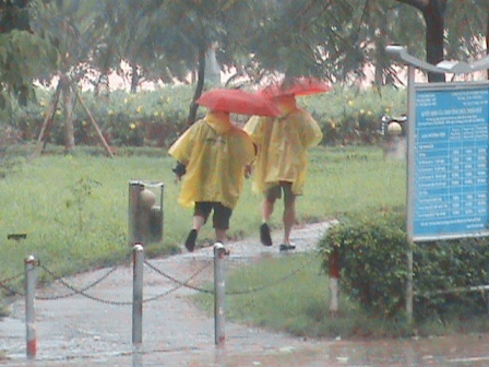 3 khách nam Tây đội dù đi trong mưa bão ở đường Lê Lợi