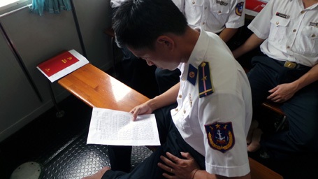 Một chiến sĩ được kết nạp Đảng đọc lại lời tuyên thệ trước khi buổi lễ diễn ra.